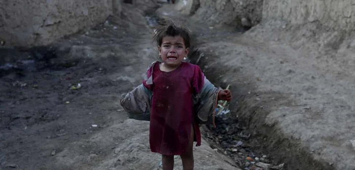 Fetiţa unor unui cuplu afgan, la marginea unei tabere de refugiaţi. FOTO Reuters