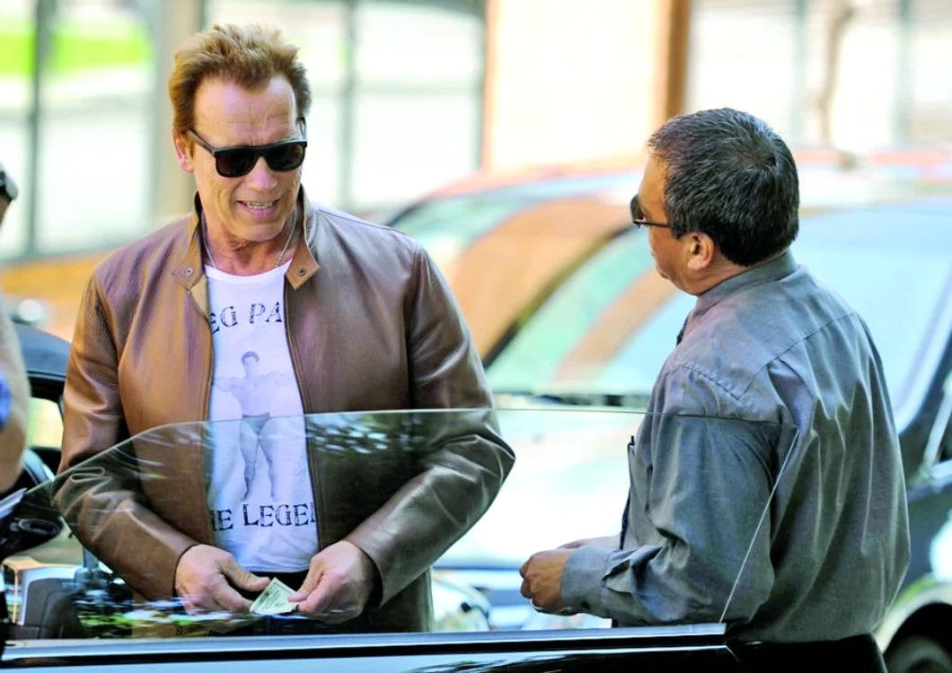 
    După ce îi deschide  uşa, Arnold îi dă  valetului 50$ (foto: Guliver / Splashnews)  
