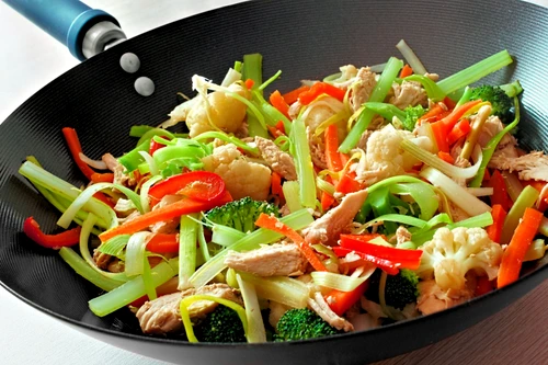 Stir fry with mixed vegetables and chicken in a wok jpeg