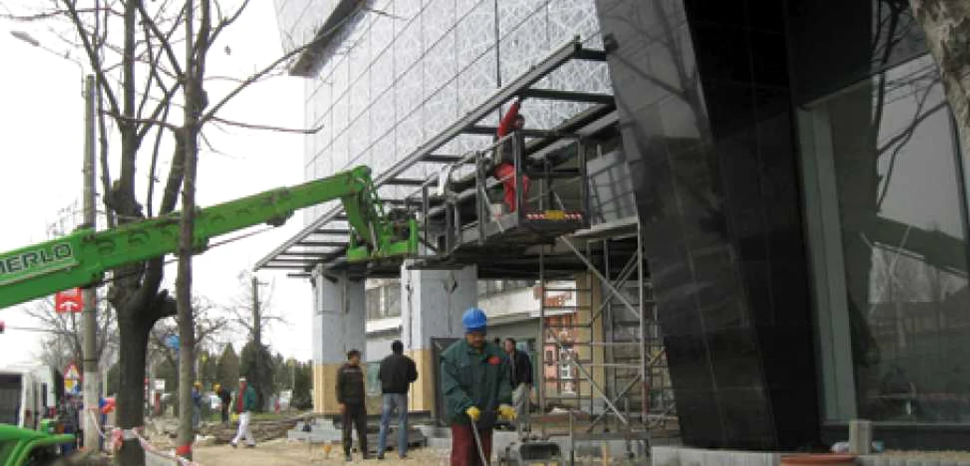 Muncitorii lucrează de zor la ultimele finisări a zonei pietonale de lângă Atrium Center